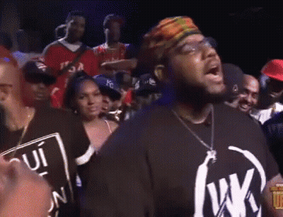 Man In Black Shirt With Letter W In Front Of Crowd GIF