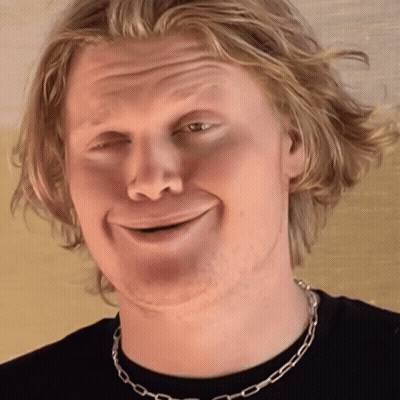 Man In Black Shirt With Silver Chain Smiling GIF