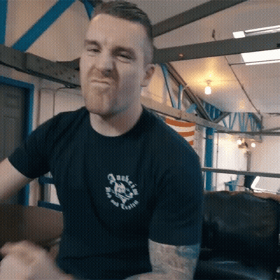 Man In Black Shirt With Skull Making A Face GIF