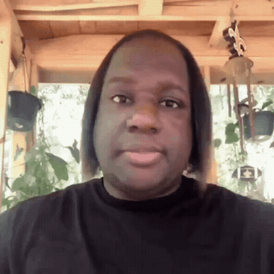 Man In Black Shirt With Wind Chime GIF