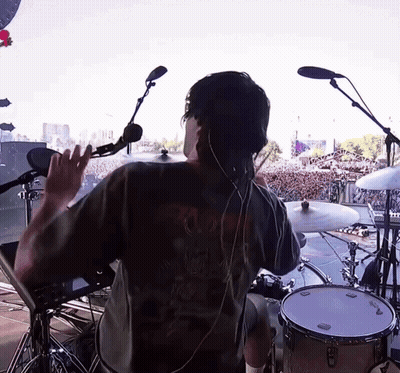 Man In Black Skull Shirt Playing Drums GIF