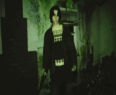 Man In Black Skull Shirt Pointing At Camera GIF