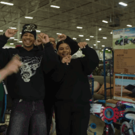 Man In Black Skull Sweatshirt Next To Woman GIF
