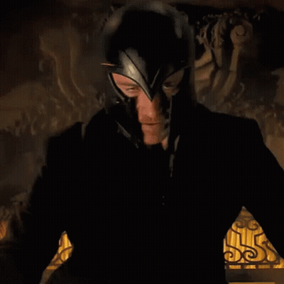 Man In Black Suit And Helmet Standing At Statue GIF