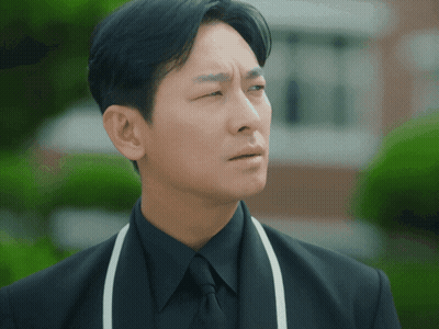 Man In Black Suit And White Apron GIF