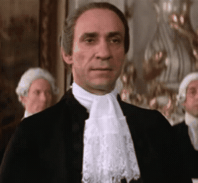 Man In Black Suit And White Lace Scarf GIF