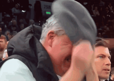 Man In Black Suit Bending Over On Knees GIF