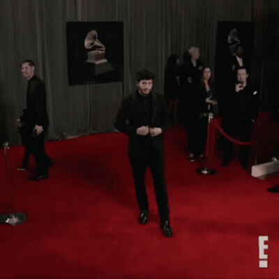 Man In Black Suit Dancing On Red Carpet GIF