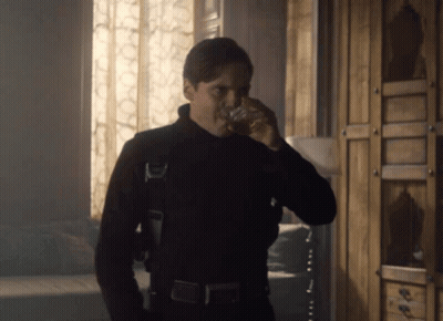 Man In Black Suit Drinking From Glass GIF
