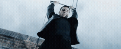 Man In Black Suit Hanging On Rope GIF