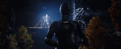 Man In Black Suit Holding Glowing Object GIF