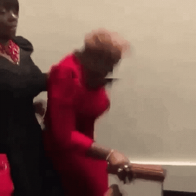 Man In Black Suit Holding Woman In Red Dress GIF