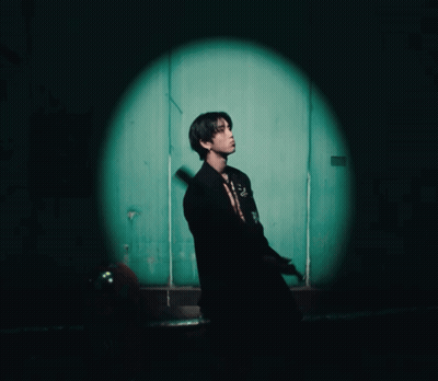 Man In Black Suit In Front Of Green Door GIF