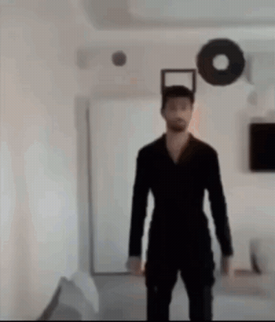 Man In Black Suit In Living Room GIF