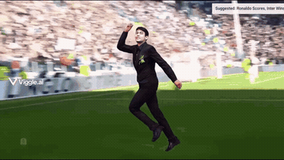 Man In Black Suit Jumping On Soccer Field GIF