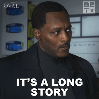 Man In Black Suit Says It's A Long Story GIF