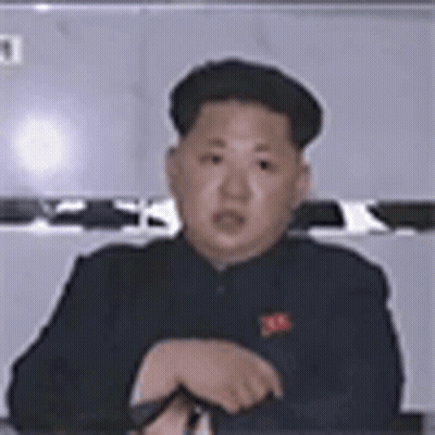 Man In Black Suit Sitting At Table GIF