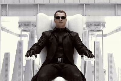 Man In Black Suit Sitting On White Chair GIF