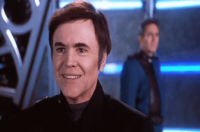Man in Black Suit Smiling in Front of Man in Blue Suit