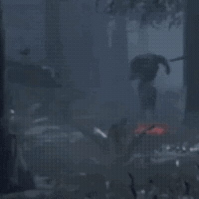 Man In Black Suit Standing In Dark Forest GIF