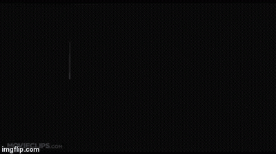 Man In Black Suit Standing In Dark Room GIF