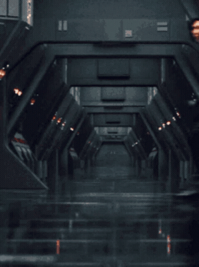 Man In Black Suit Standing In Hallway With Hands In Pockets GIF