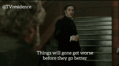 Man In Black Suit Standing Next To Woman Saying Things Will Get Worse Before They Get Better GIF