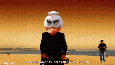 Man In Black Suit Standing On Beach GIF