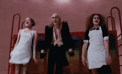 Man In Black Suit Surrounded By Two Women GIF