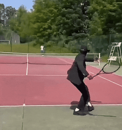 Man In Black Suit Swinging Tennis Racquet GIF