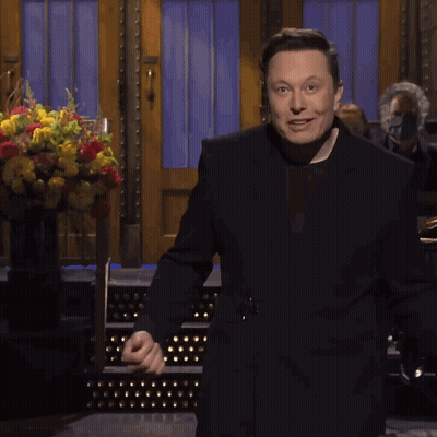 Man In Black Suit With Flowers GIF