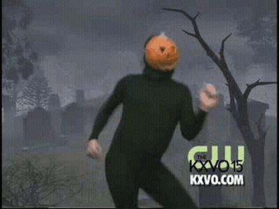 Man In Black Suit With Pumpkin Head Dancing In Cemetery GIF