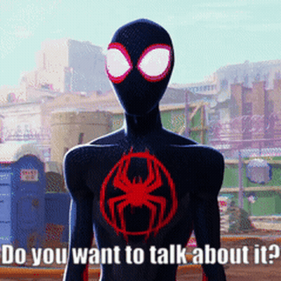 Man In Black Suit With Red Spider Says Do You Want To Talk GIF