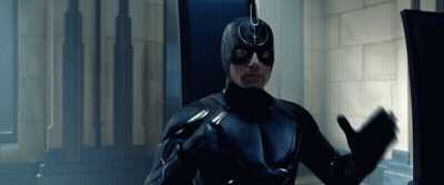 Man In Black Superhero Costume At Computer GIF