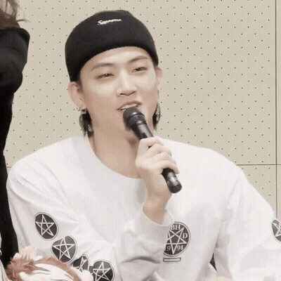 Man In Black Supreme Headband Holding Microphone GIF