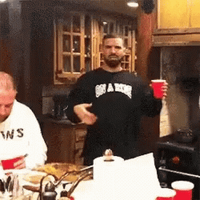 Man In Black Swans Shirt Holding Red Cup GIF