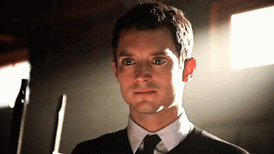 Man In Black Sweater And Tie Holding Knife GIF