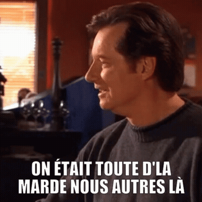 Man in Black Sweater at Table With French Caption