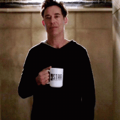 Man In Black Sweater Holding Coffee Mug Saying Star GIF