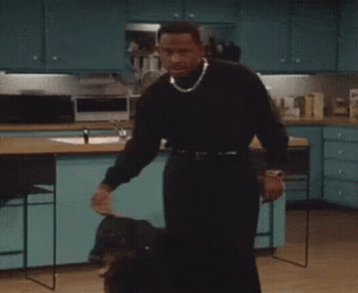 Man In Black Sweater Holding Dog GIF