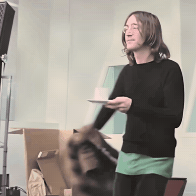 Man In Black Sweater Holding Plate GIF