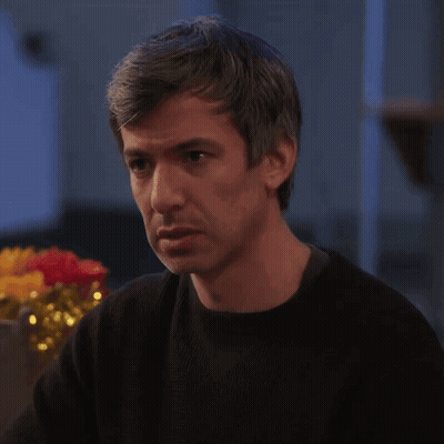 Man In Black Sweater Looking At Something GIF