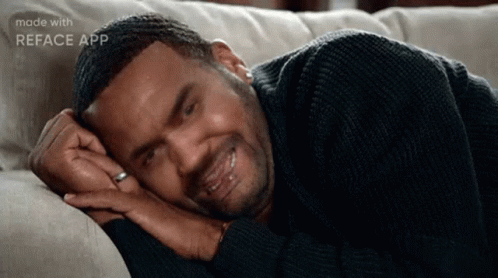 Man In Black Sweater Lying On Couch GIF