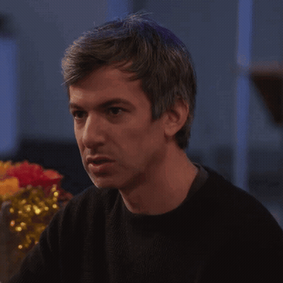 Man In Black Sweater Sitting At Table GIF