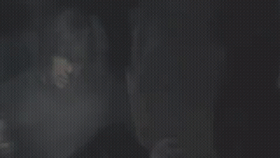 Man In Black Sweater Standing Before Crowd GIF