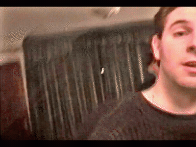 Man In Black Sweater With Striped Curtain GIF