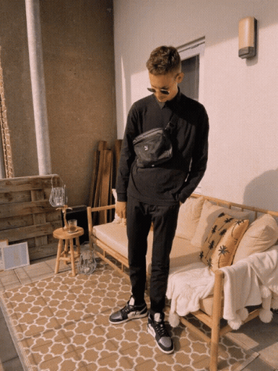 Man In Black Sweatshirt And Pants By Wooden Couch GIF