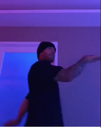Man in Black T-Shirt and Beanie Making Funny Face