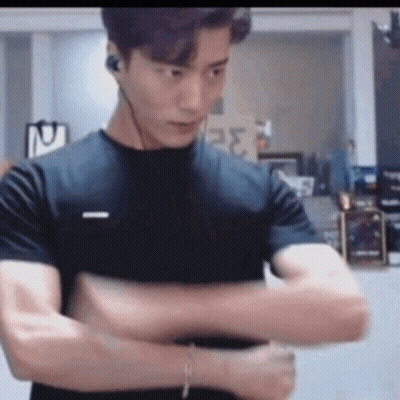Man In Black T-Shirt And Headphones With Arms Crossed GIF