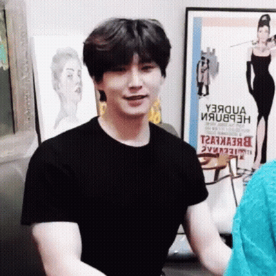 Man In Black T-Shirt In Front Of Y3aqua Poster GIF